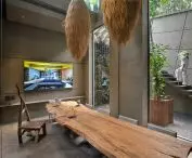 Modern interior with rustic wooden table and wall-mounted TV