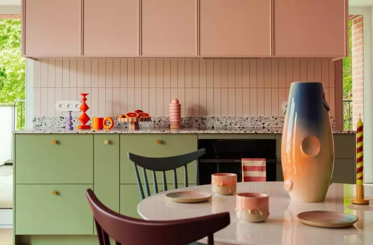 The kitchen is dominated by soft pink
