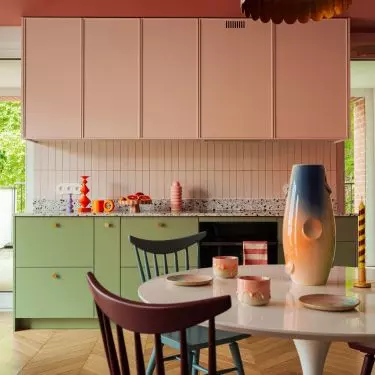 The kitchen is dominated by soft pink