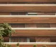 The deep white canopies, called chhajjas, protect residents of the Carmichael high-rise residential building from the sun and rain, combining aesthetics with functionality in a tropical climate.