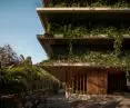 A view of the lower floors of the Carmichael residential tower shows how greenery intertwines with architecture