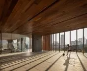 A gym and yoga terrace on the recreation floor of the Carmichael residential high-rise offers residents a place to relax and be active surrounded by natural greenery, supporting the building's eco-friendly character