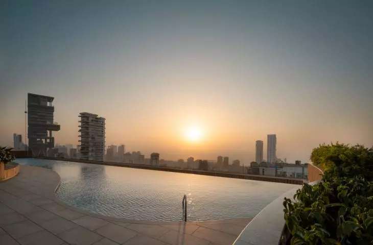 Carmichael high-rise residential building's roof houses a swimming pool and photovoltaic panels, introducing sustainable solutions that support the move toward climate neutrality