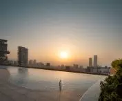 Carmichael high-rise residential building's roof houses a swimming pool and photovoltaic panels, introducing sustainable solutions that support the move toward climate neutrality