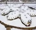 Aerial view of snow-covered flower petal-shaped building