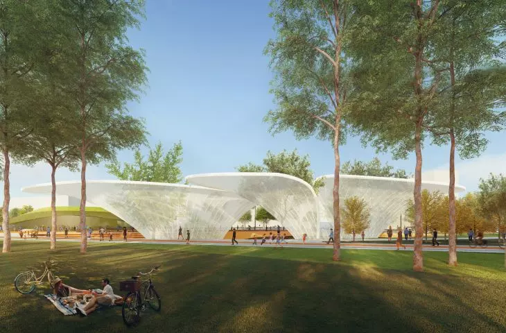Park with trees, green lawn and modern white structures