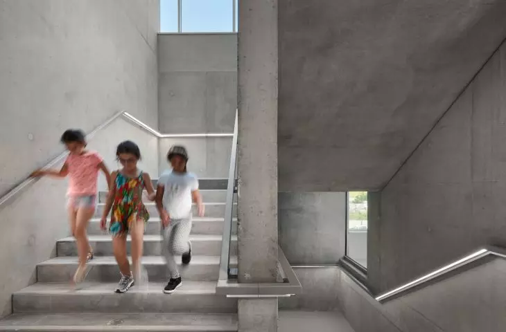 Children descending modern concrete stairs