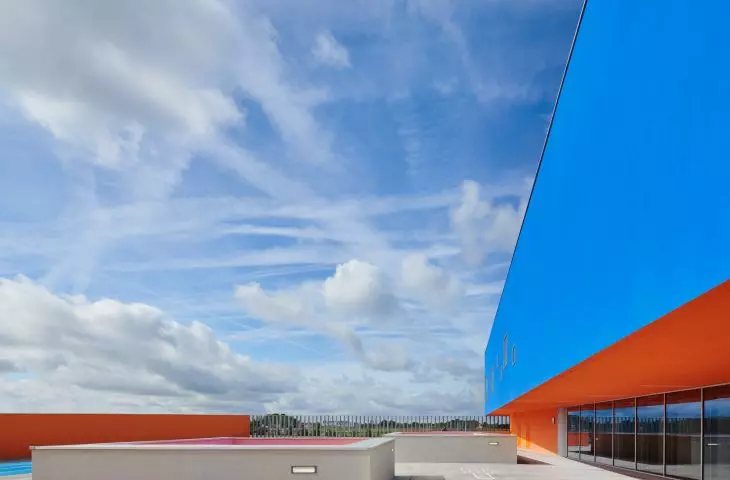 Modern roof with striking blue wall and orange accents