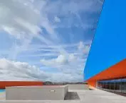 Modern roof with striking blue wall and orange accents