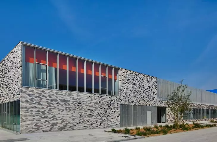Modern building with patterned brick wall and large windows
