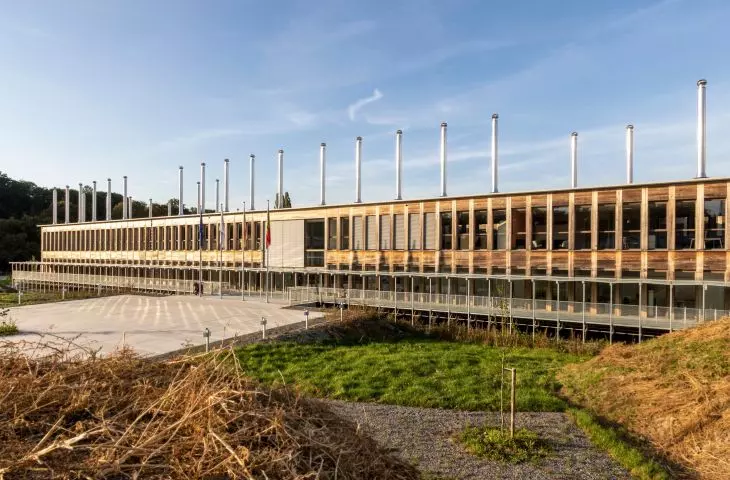 Modern building with wooden panels and vertical roof columns