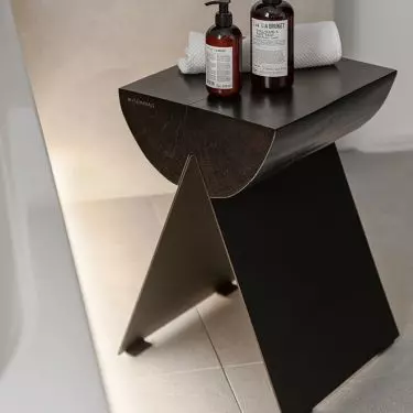 The stool was made from a raw tree trunk on sheet metal legs