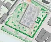 Aerial view of modern rectangular building surrounded by greenery and urban structures