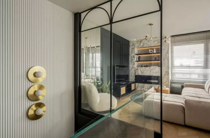 A glass balustrade with arches takes up an entire wall