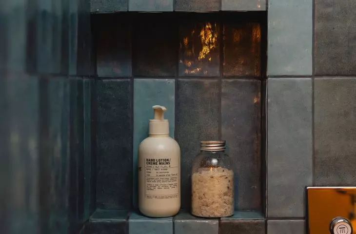 The walls of the shower are lined with blue tiles