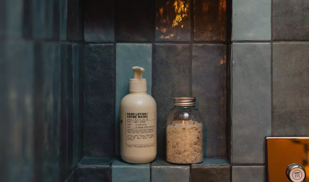 The walls of the shower are lined with blue tiles