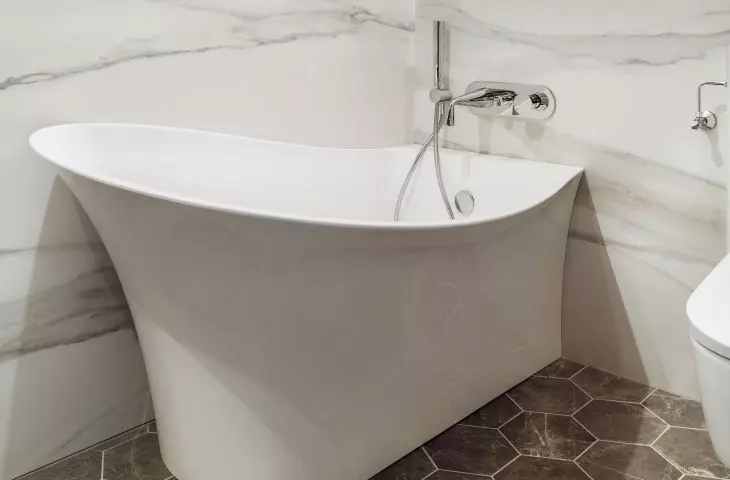 Freestanding bathtub with an interesting shape adds character to the interior
