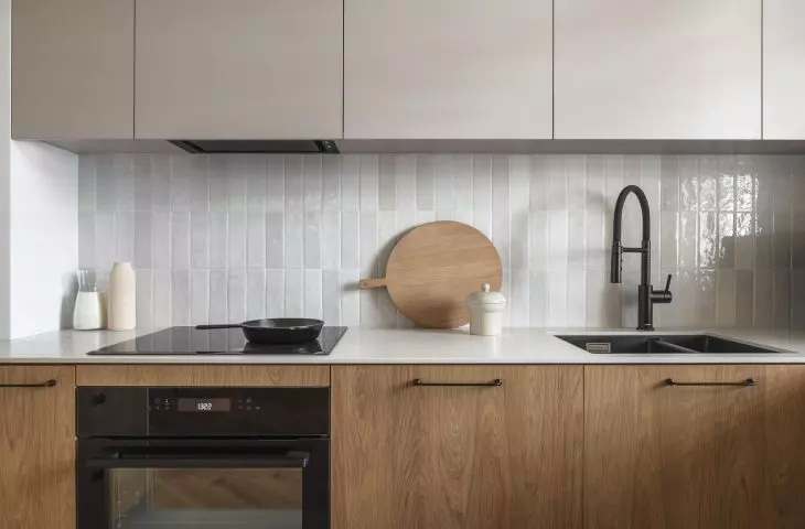 The wall above the countertop was finished with glossy tiles