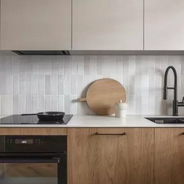 The wall above the countertop was finished with glossy tiles