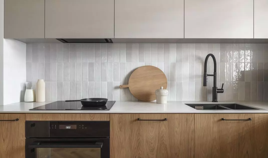 The wall above the countertop was finished with glossy tiles