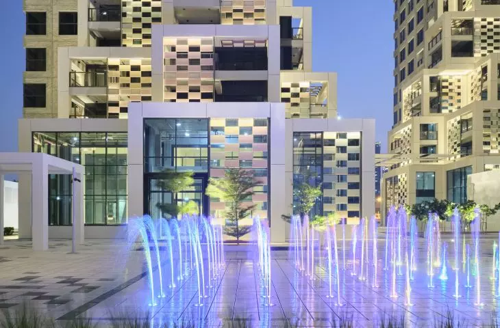 Pixel residential development on Reem Island in Abu Dhabi - the square has been enriched with vegetation, fountains and water elements to improve the microclimate