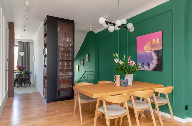 One of the walls with paintings was painted in a shade of deep green