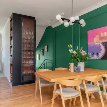 One of the walls with paintings was painted in a shade of deep green
