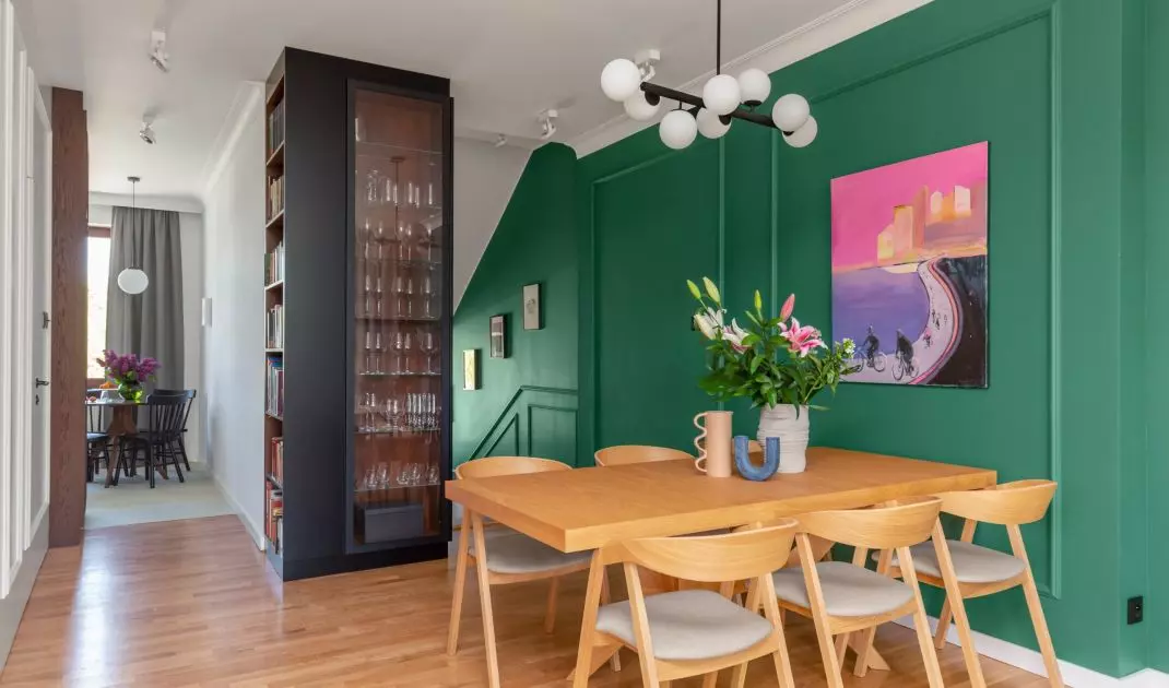 One of the walls with paintings was painted in a shade of deep green