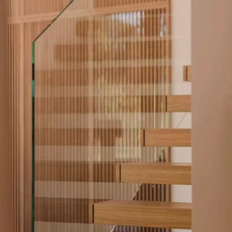 The staircase leading to the mezzanine looks as if it is floating in the air