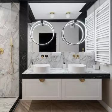 The circular lighting follows the shape of countertop washbasins