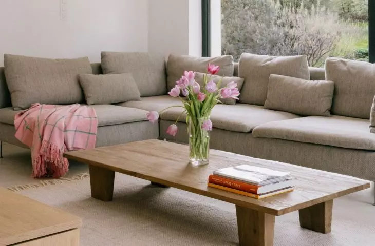 Gray modular sofa harmonizes with wooden table