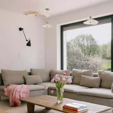 Gray modular sofa harmonizes with wooden table