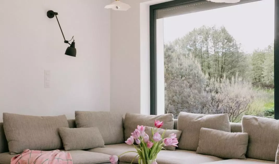 Gray modular sofa harmonizes with wooden table