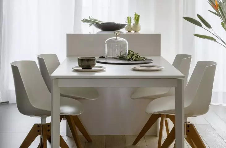 Lamps with wooden details hang in the living area