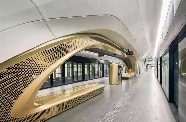 King Abdullah Financial District (KAFD) metro station in Riyadh - the interior space is enhanced by white concrete panels, patterned floors and gold-tone details
