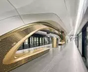 King Abdullah Financial District (KAFD) metro station in Riyadh - the interior space is enhanced by white concrete panels, patterned floors and gold-tone details