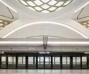 King Abdullah Financial District (KAFD) metro station in Riyadh - the interior space is enhanced by white concrete panels, patterned floors and gold-tone details