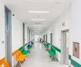 Highly reflective white hygienic ceiling helps illuminate windowless corridors