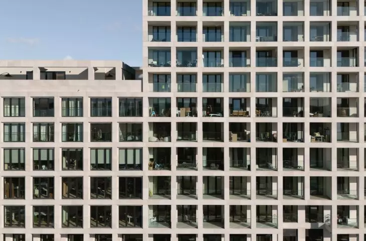 Scheldehof residential complex in Nieuw Zuid, Antwerp - limestone elements form an openwork structure that wrap around the walls like a net