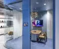 Perfect combination of bent corner wall on GSW Office Plus double-glazed system, glass panel with screen for conference room access management and Purian doors