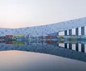 Wuhan ski resort - the facade of the building housing the slope consists of cascading, interactive modules resembling pixels