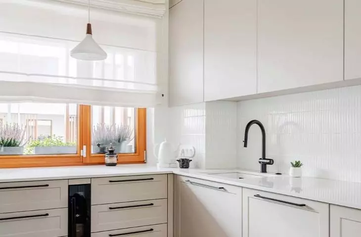 The kitchen cabinets have a light gray hue