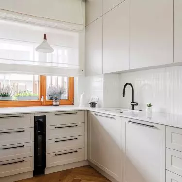 The kitchen cabinets have a light gray hue
