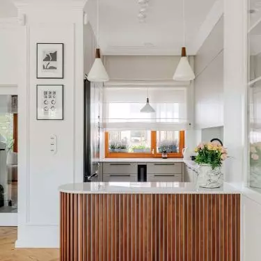 The wall in the kitchen area is decorated with graphics collected by the investor