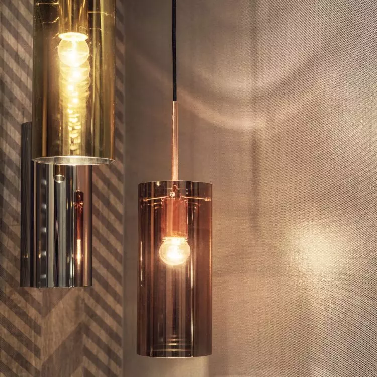 Decorative lighting in the form of gold and copper tubes adds to the coziness