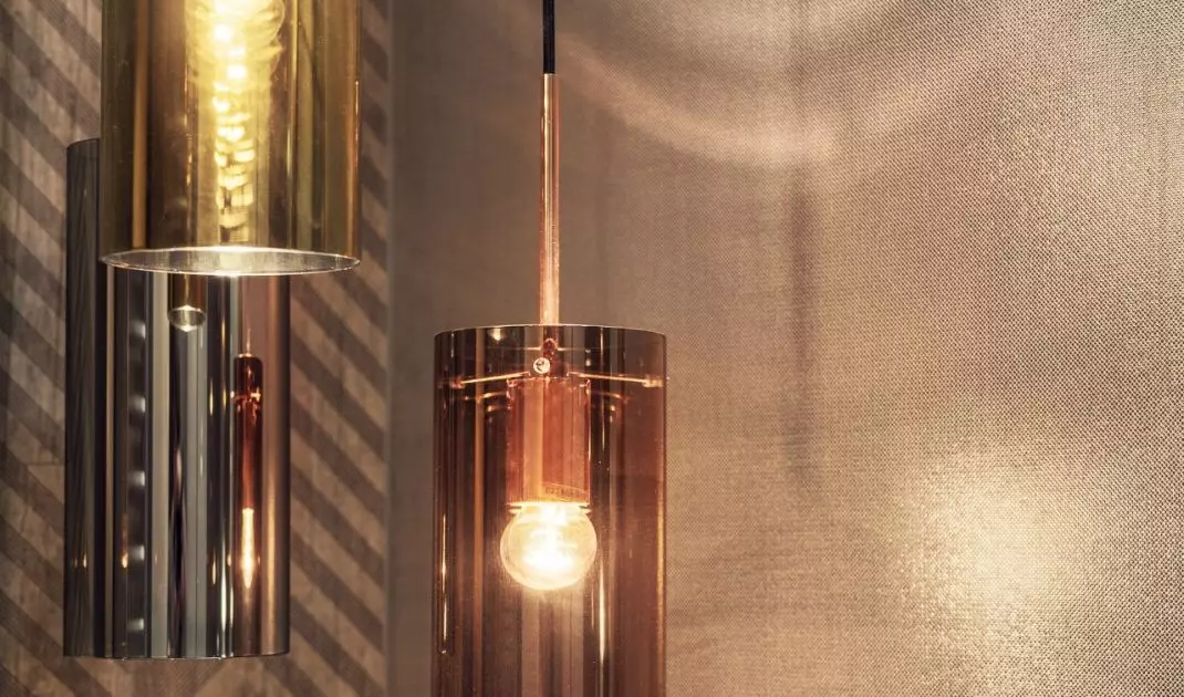 Decorative lighting in the form of gold and copper tubes adds to the coziness
