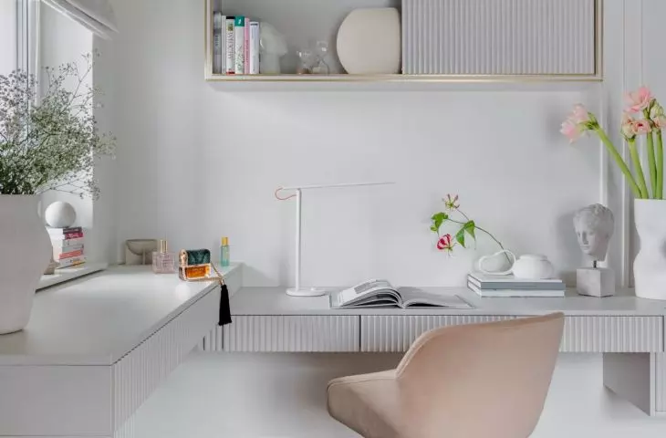 The arrangement of the work corner is consistent with the rest of the room
