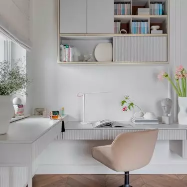 The arrangement of the work corner is consistent with the rest of the room