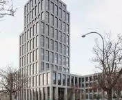 INCUBA Next skyscraper in Aarhus, Denmark - the glazed facade is covered by an openwork structure of light-colored bricks