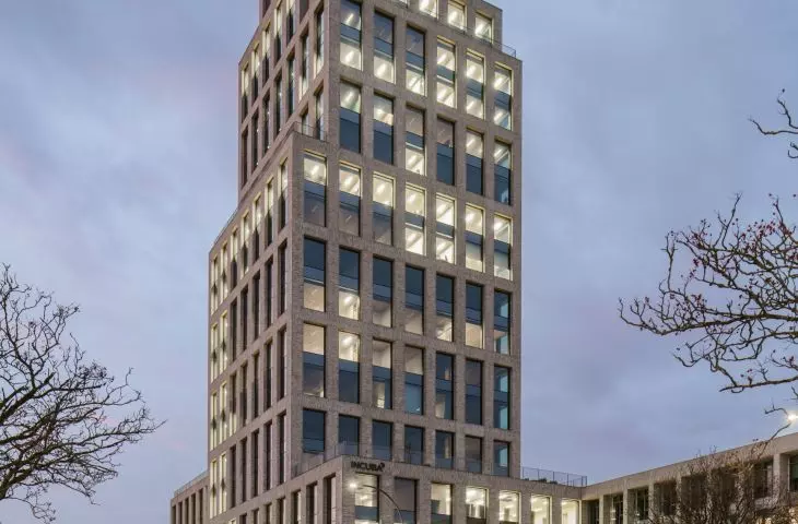 INCUBA Next skyscraper in Aarhus, Denmark - the glazed facade is covered by an openwork structure of light-colored bricks